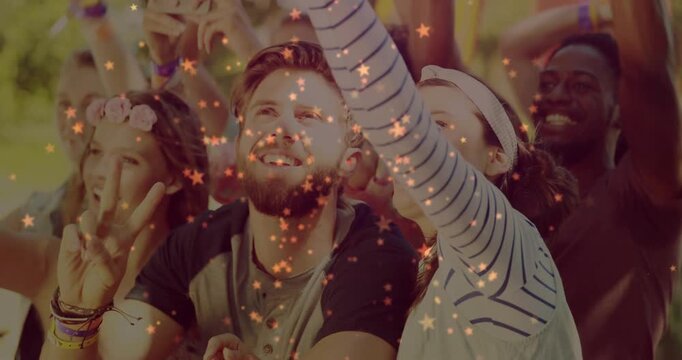 Vertical video: Group reacting to music act, cheering, filming on phone, stars drifting over faces