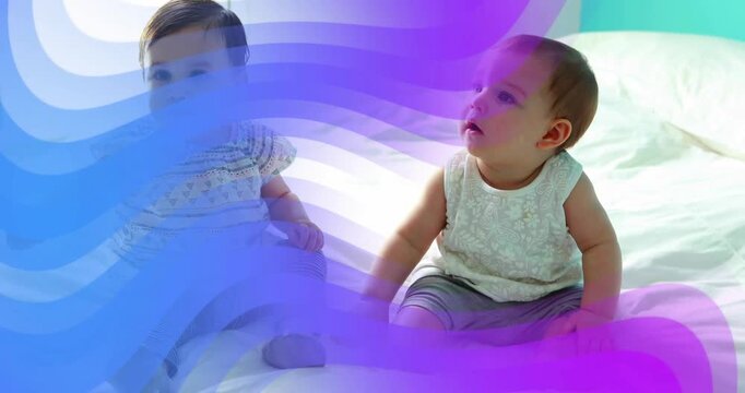 Left baby reaching right baby, seeking touch while purple overlay sweeping over babies for parents