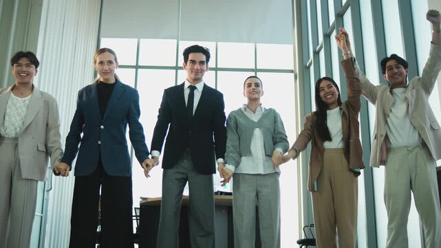 Multiracial Businessperson united commitment partnership, hand raises together, synergy and harmony business company worker with solidarity goal motivation, group of professional teamwork in firm.