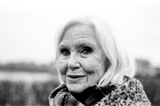 Kim novak smiling in a grainy monochrome film portrait