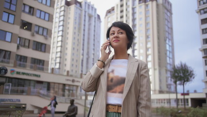 Fototapeta premium Businesswoman Talking on Phone in Urban Area, have fun and enjoy