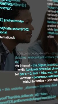 Vertical video: Man speaking to peer causing code overlay covering laptop, faces during tech review