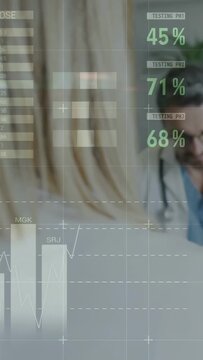 Vertical video: HUD overlaying, patient sitting as doctor reading health data on tablet for care