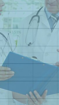 Vertical video: Two MDs man pointing at blue binder, woman scanning, charts showing medical stats