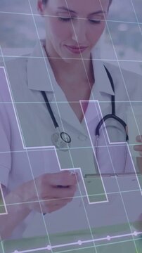 Vertical video: Nurse holding clipboard and noting chart for records with steth, grid marking data