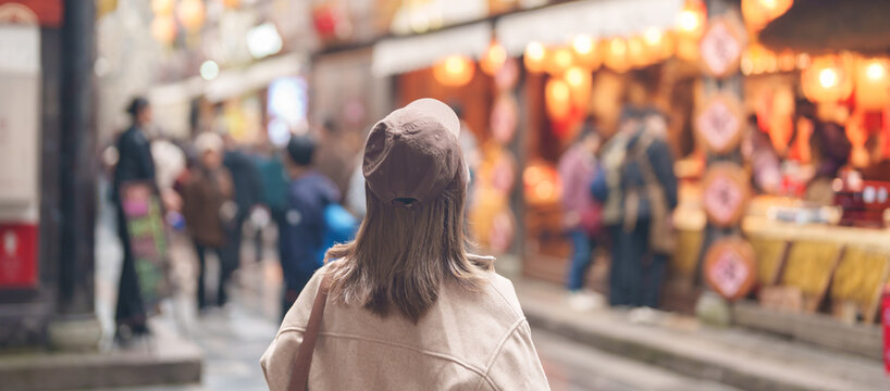 Happy woman traveler travel in Chengdu city. Tourist sightseeing and shopping in Jinli Ancient Street. Famous Landmark for tourism attraction in Sichuan, China