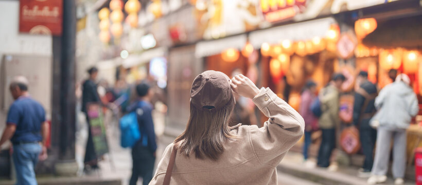 Happy woman traveler travel in Chengdu city. Tourist sightseeing and shopping in Jinli Ancient Street. Famous Landmark for tourism attraction in Sichuan, China