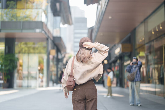 woman traveler travel in Chengdu city. Happy Tourist sightseeing in Taikoo Li Chengdu, located in the Jinjiang District, near the Chunxi Road. Famous landmark for tourism attraction in Sichuan, China