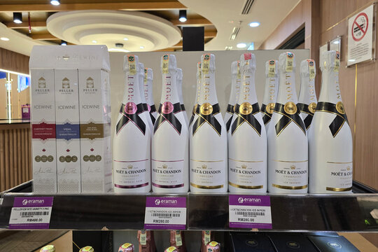 Penang, Malaysia: Jan 06, 2026: A shelf display at Eraman duty-free shop in Penang International Airport featuring bottles of Moet & Chandon Ice Imperial Champagne and Peller Estates Icewine.
