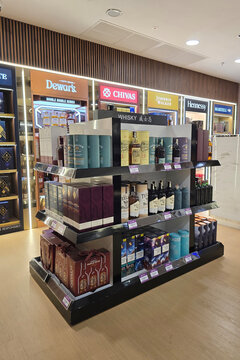 Penang, Malaysia- Jan 06, 2026: Various international whisky brands including Dewar's, Chivas, and Johnnie Walker displayed on retail shelves at a duty free shop in Penang International Airport.