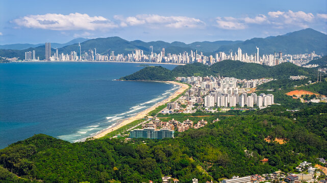 Aerial view of Praia Brava in Itajai with Balneario Camboriu skyline visible in the background, Santa Catarina.