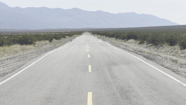 Empty Desert Highway Stretching to the Mountains in Death Valley