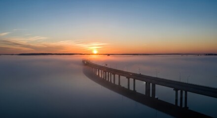 Obraz premium Sunrise Over Foggy River With Bridge And Cars Driving