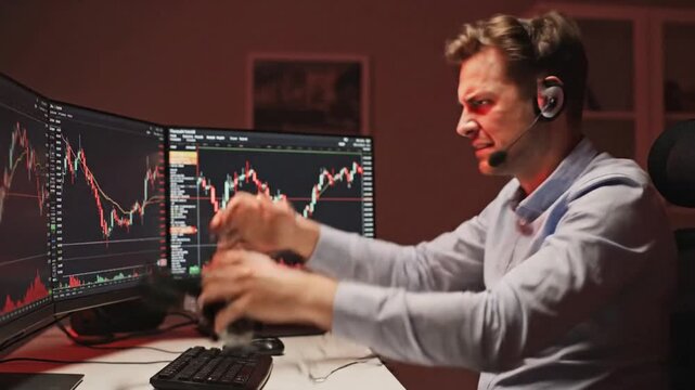 Frustrated millennial trader shouting at computer monitor due to financial loss in stock market and volatile cryptocurrency investment, portraying stress, risk, and failure in digital equities.