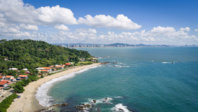 Aerial view of Bacia da Vov&oacute; and Praia da Saudade with calm waters and coastal landscape on sunny day.
