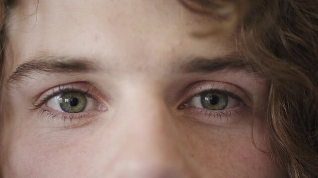 Face, eyes and person with optometry at clinic, vision assessment or contact lenses for visual correction. Eye care, portrait and man with myopia check for optical wellness, eyesight test and blink