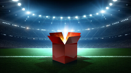 Obraz premium An open glowing red gift box on a soccer stadium field at night. An imaginary soccer stadium is modelled and rendered.