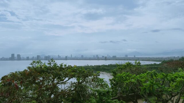 Breathtaking Top View of Son Tra Peninsula and Winding Mountain Pass, Da Nang
the dramatic winding mountain road cutting through lush tropical jungle, with the distant coastline and city skyline 