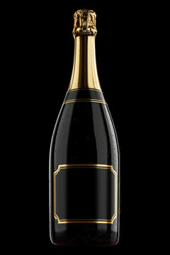 Closed champagne bottle with golden foil and sparkling wine inside no label on dark backdrop with clipping path