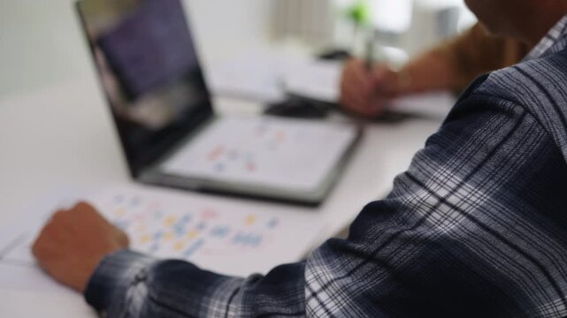 senior developers collaborating in brainstorming and coding project at office workspace