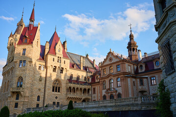 Fototapeta premium Moszna castle in Opole, Poland. Historic castle facade with ornate towers. Concept of architectural heritage, travel destination and European landmark