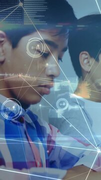 Vertical video: Plaid-shirt student writing with pen, camera pan and HUD graphs overlaying learning