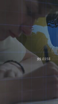 Vertical video: Teen leaning in writing notes with pen while peer watching overlaying map 99