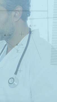 Vertical video: Pullback revealing doctor diagnosing patient using HUD and stethoscope by window