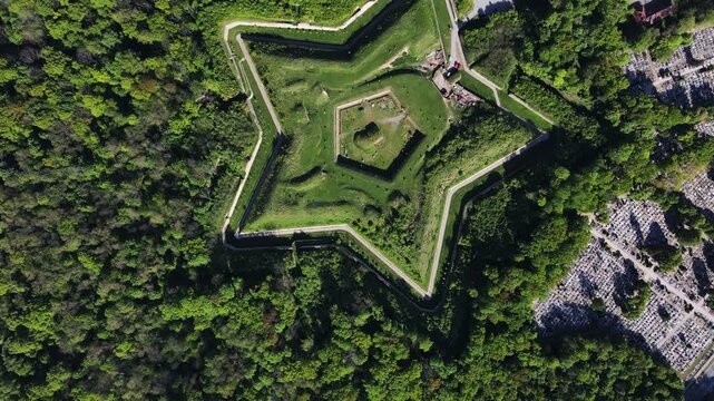 Aerial view of historic Prusy Fort surrounded by forest and urban area in Nysa, Poland. Concept of military architecture, cultural heritage and travel destination