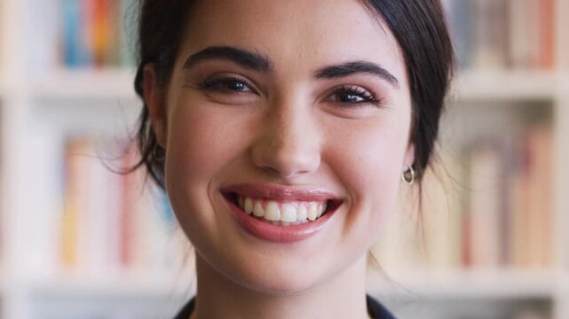 Face, university student and woman in library, smile and scholarship for academy knowledge. Higher education, happiness and person with confidence, learning and studying for phd degree and research