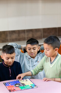 Latin american kids playing board game at home