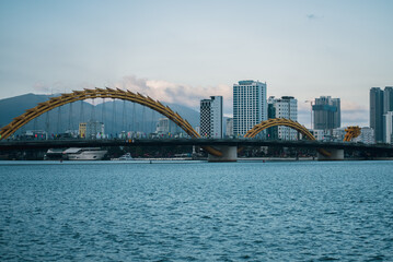 Obraz premium Dragon Bridge crossing Han River in Danang at sunset, iconic Vietnam city landmark, Famous Dragon Bridge cityscape in Da Nang during twilight