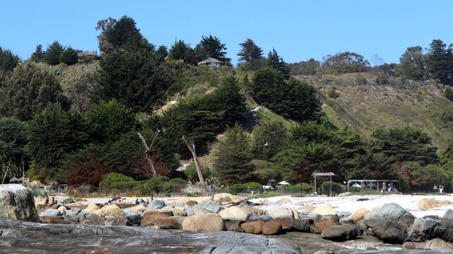 Scenic view of El Tebo beach with white sand, rocks and coastal forest in Valparaiso region, Chile