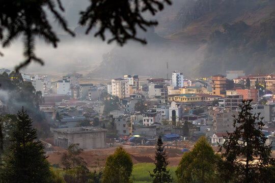 A scenic view of the town of Dong Van, Ha Giang, Vietnam, showcasing the unique architecture and urban landscape. The image captures the essence of daily life in this vibrant city.