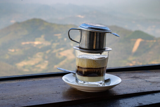 A Vietnamese coffee is being brewed in Yen Minh, Ha Giang, Vietnam. The traditional method uses a metal filter, creating a rich, strong brew, enjoyed for its unique flavor.