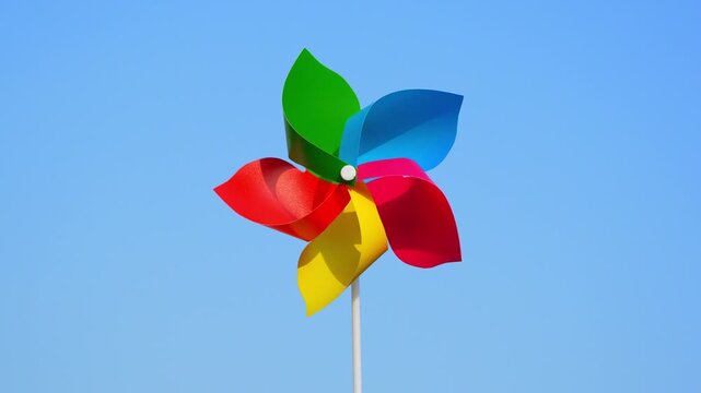The colorful rotating windmill in blue sky