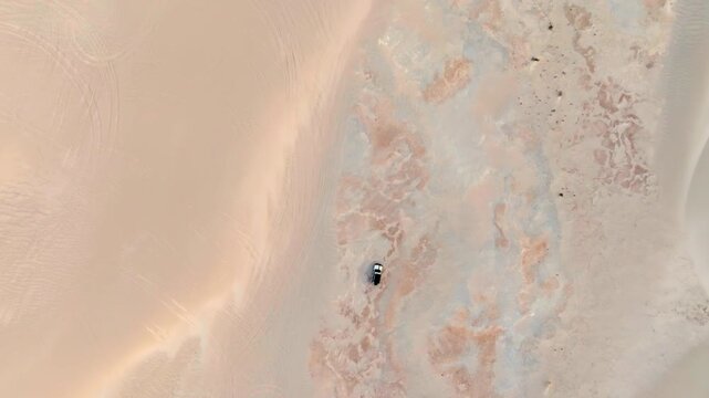 Sand dunes driving with a 4x4 filmed by drone