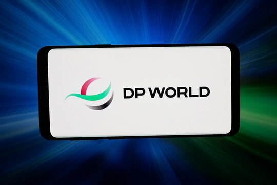 Stuttgart, Germany - 03-18-2026: In this photo illustration, the logo of Emirati logistics company DP World is displayed on a smartphone in front of abstract background on computer screen.