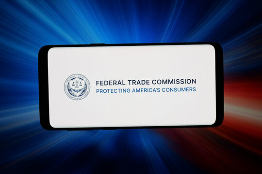 Stuttgart, Germany - 03-18-2026: In this photo illustration, the logo of US agency Federal Trade Commission (FTC) is displayed on a smartphone in front of abstract background on computer screen.