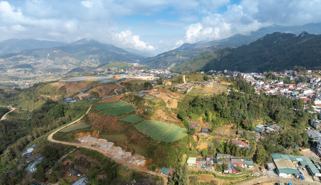 Aerial view of the terraced rice fields and villages in Sa Pa, Vietnam. The Hmong people farm the land, creating a beautiful landscape in Lao Cai province.