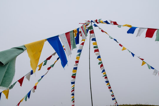 Prayer flags blowing in the wind in the hills of Sa Pa, Lao Cai, Vietnam. The flags are used to promote peace, compassion, strength, and wisdom in the world.