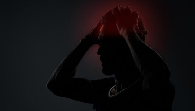 Man in shadow with red glowing headache suitable for medical articles, migraine awareness campaigns, and mental health blog illustrations.
