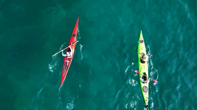 Aerial drone top down cinematic video of athletes practice sport canoe in tropical exotic island emerald crystal clear calm sea