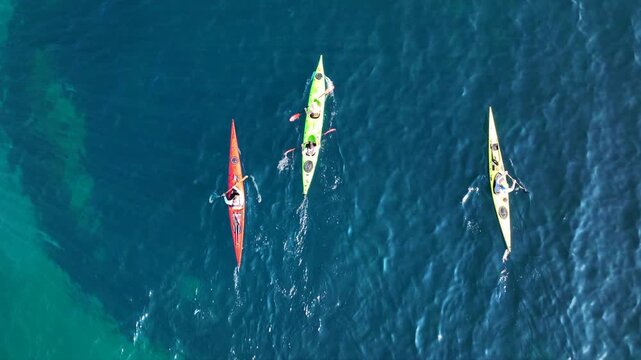 Aerial drone top down cinematic video of athletes practice sport canoe in tropical exotic island emerald crystal clear calm sea