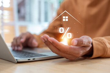 Mortgage Interest Rate Analysis and Real Estate Investment Planning with Financial Data on Laptop Screen.