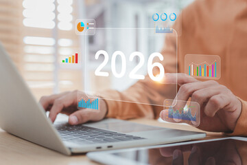 Businessman planning business strategy for year 2026, analyzing financial growth and future performance.