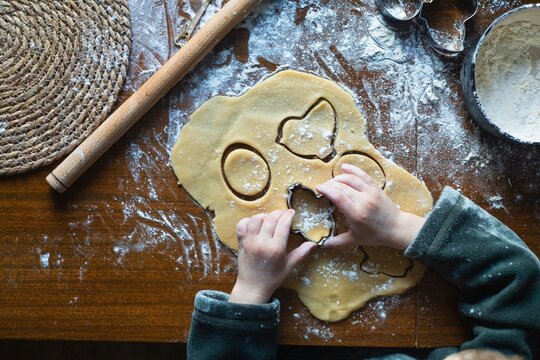 child's hands using metal cutters