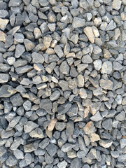 Naklejka premium Small Gray and Beige Gravel Stones Close-up Texture