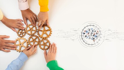 Obraz premium A diverse group of hands working together on wooden gears represents innovation and teamwork in a modern workspace, highlighting collaboration for success. Raster