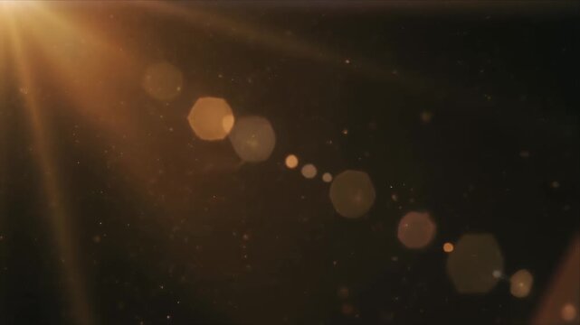 Golden lens flare bokeh streak across dark frame.